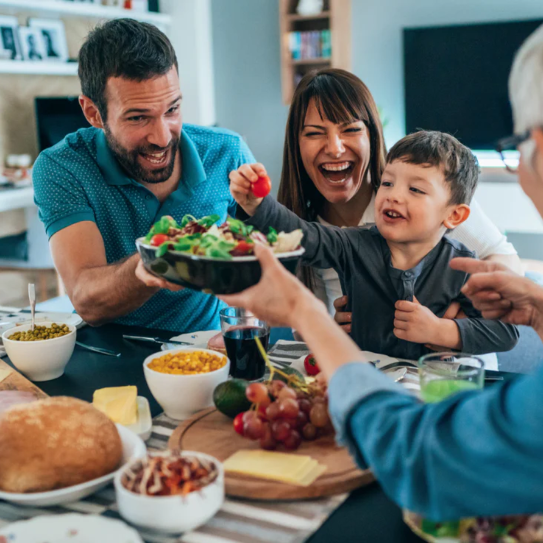 Happy Family Eating Dinner Salad Together.