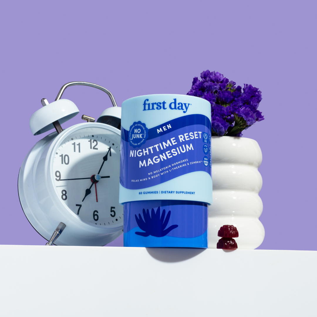 Supplement package labeled 'first day' with an alarm clock and flowers on a purple background