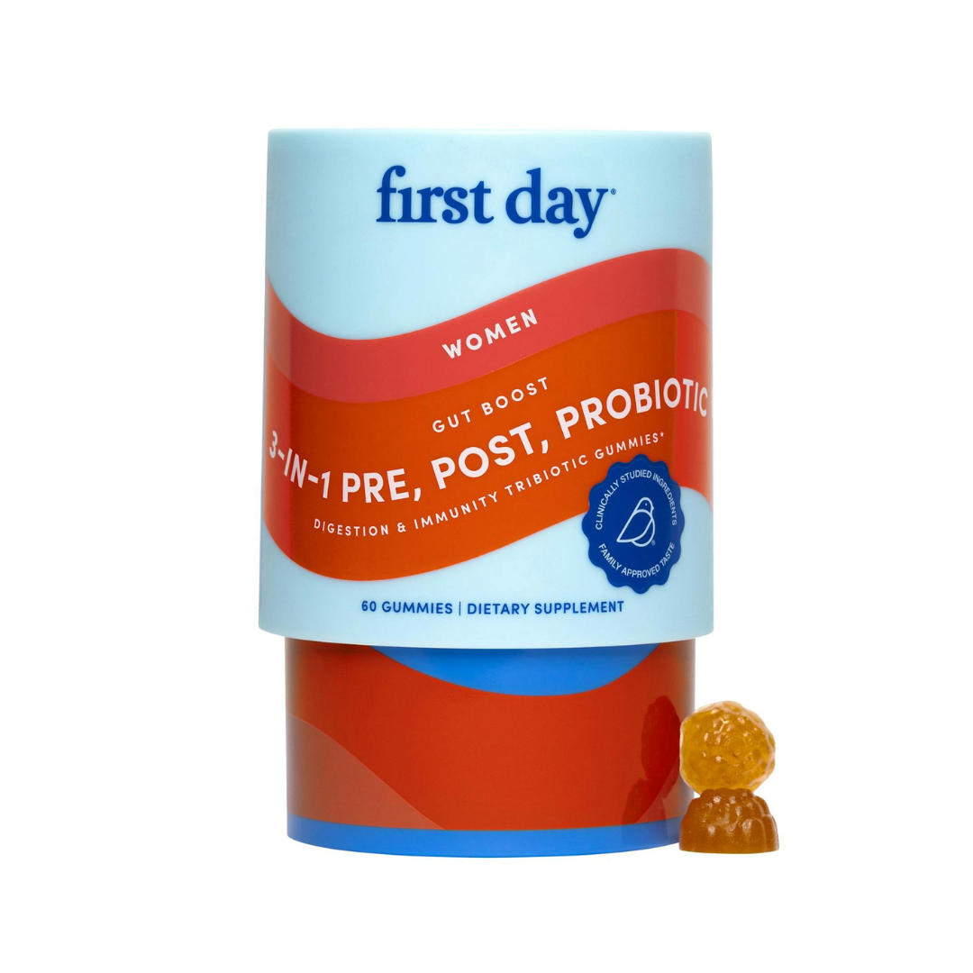 A container of First Day Life Inc. Women's 3-in-1 Pre+ Post+ Probiotic - Free Gift For Life, with two orange berry-shaped gummies beside it. The label highlights digestive health, gut boost, immune support, and vaginal health.