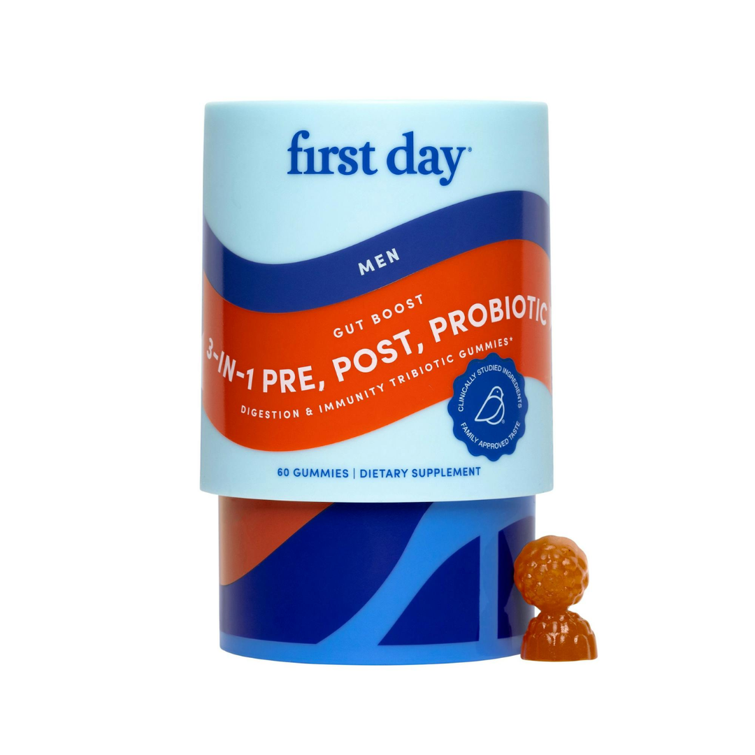 A container of Men's 3-in-1 Pre+ Post+ Probiotic stands upright, promoting gut health. An orange, sphere-shaped gummy sits in front, echoing the product's blue and orange design focused on digestive wellness.