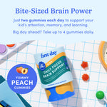 Packaging of 'first day' kids daily focus brain support gummies with educational items in the background.