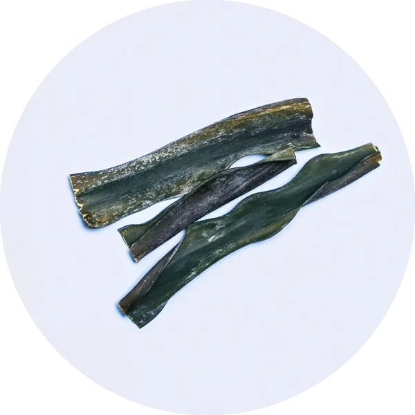 Three dark green, dried seaweed strips lying on a light background.