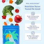 A blue kids' gummy jar labeled 'Kids Superfood Multi' with tropical parrot artwork, shown on a light blue background with floating fruits and vegetables including broccoli, apple, carrot, blueberry, and colorful star-shaped gummies. Text reads 'Real Wholesome Nutrition Never Tasted So Good' with three benefit callouts.